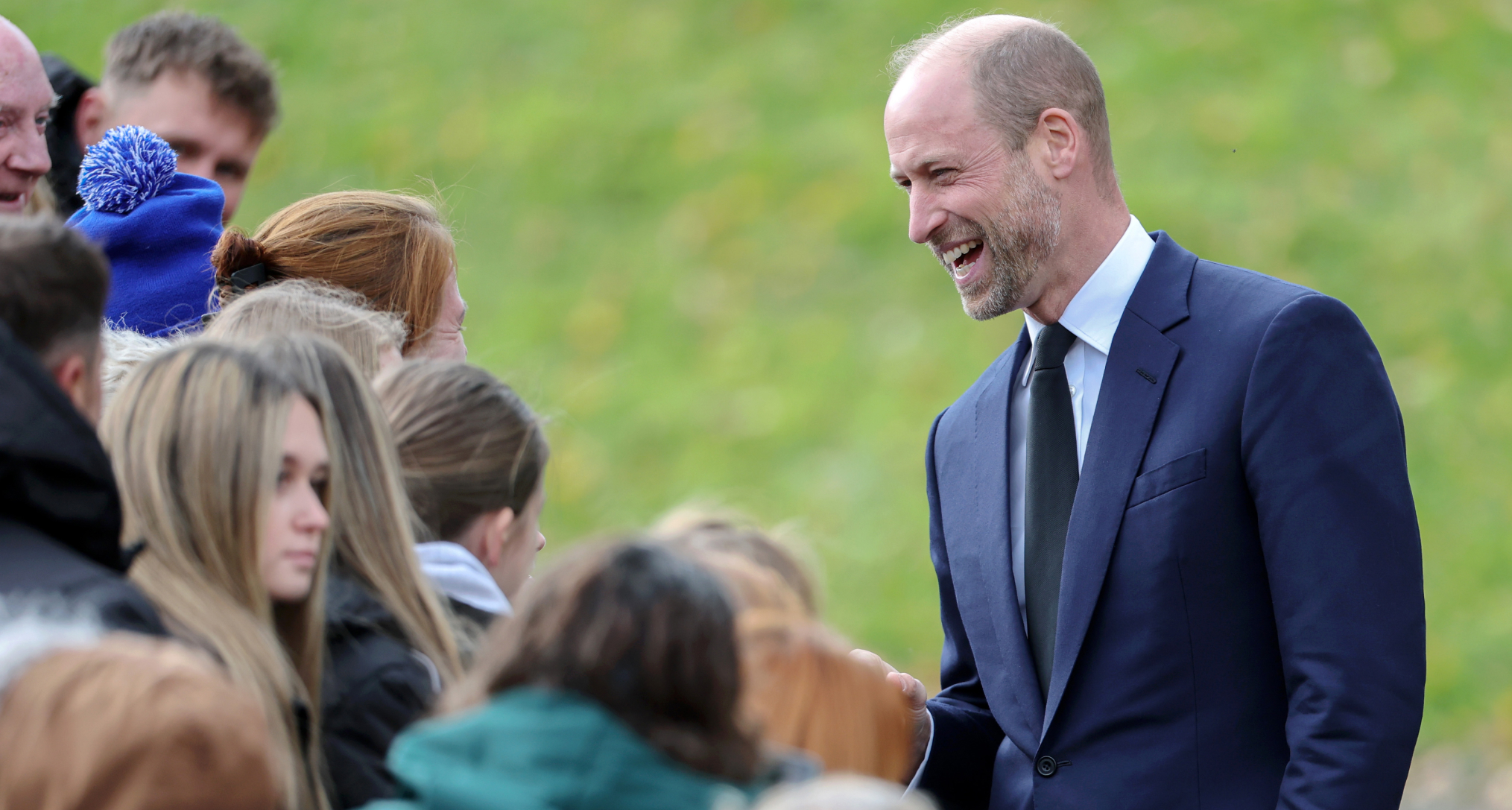 Prince WIlliam laughing and talking to fans