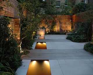 modern courtyard garden lit at night
