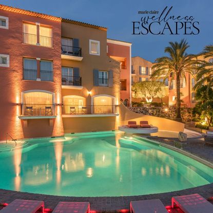 Byblos St Tropez outdoor area at night with the pool lit up and lights on