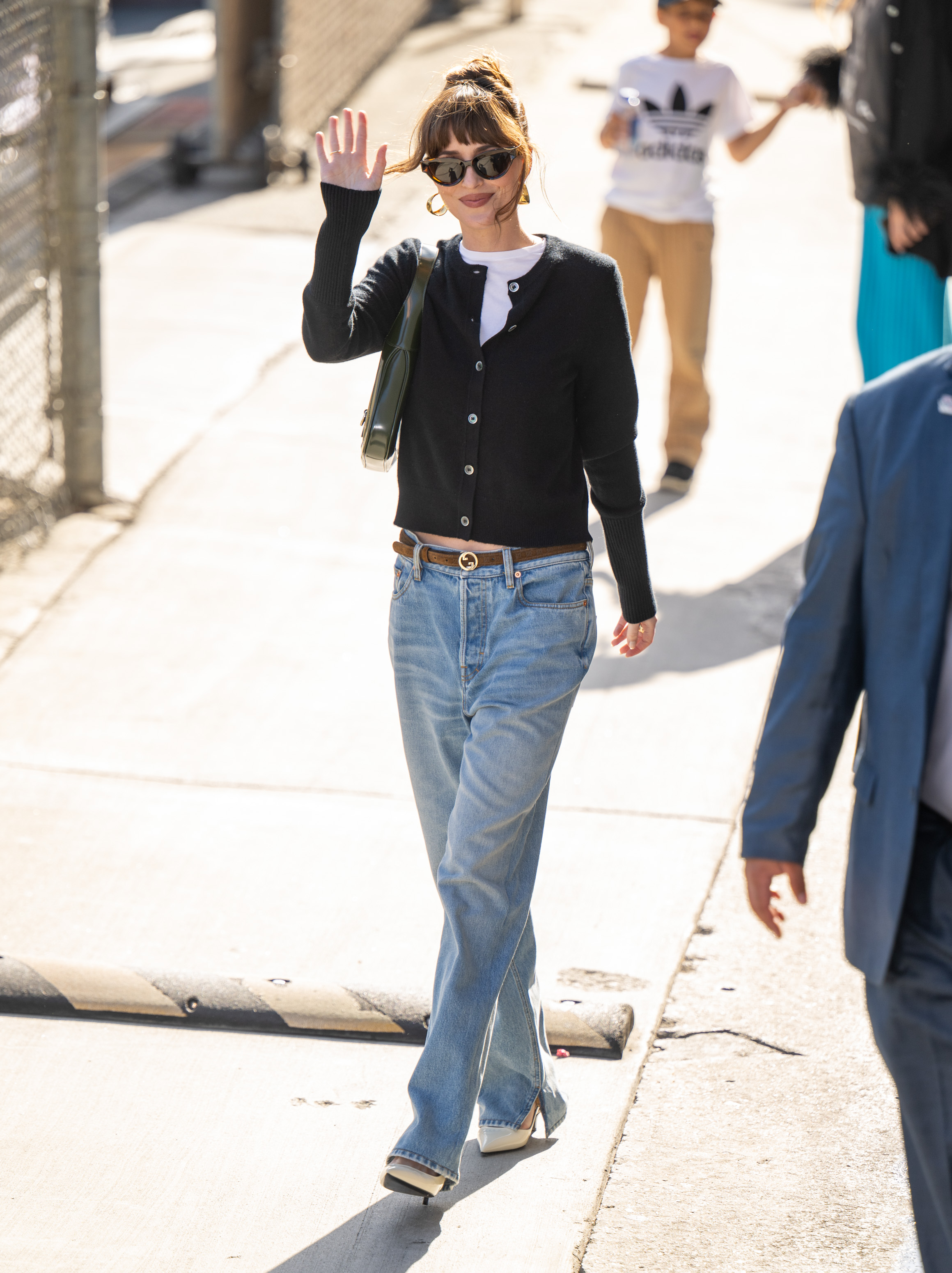 Dakota Johnson wears jeans and heels