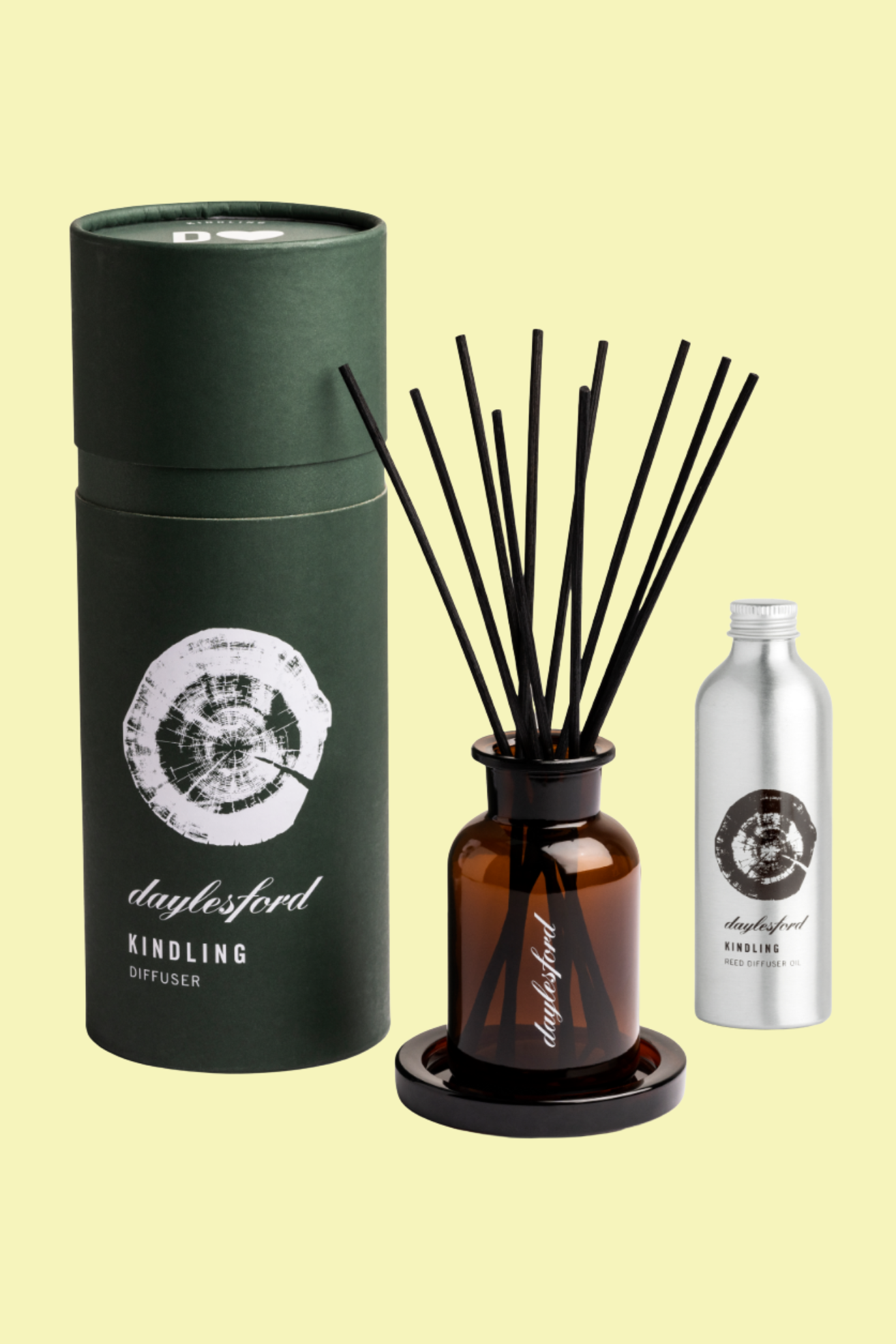 An amber reed diffuser on a coaster