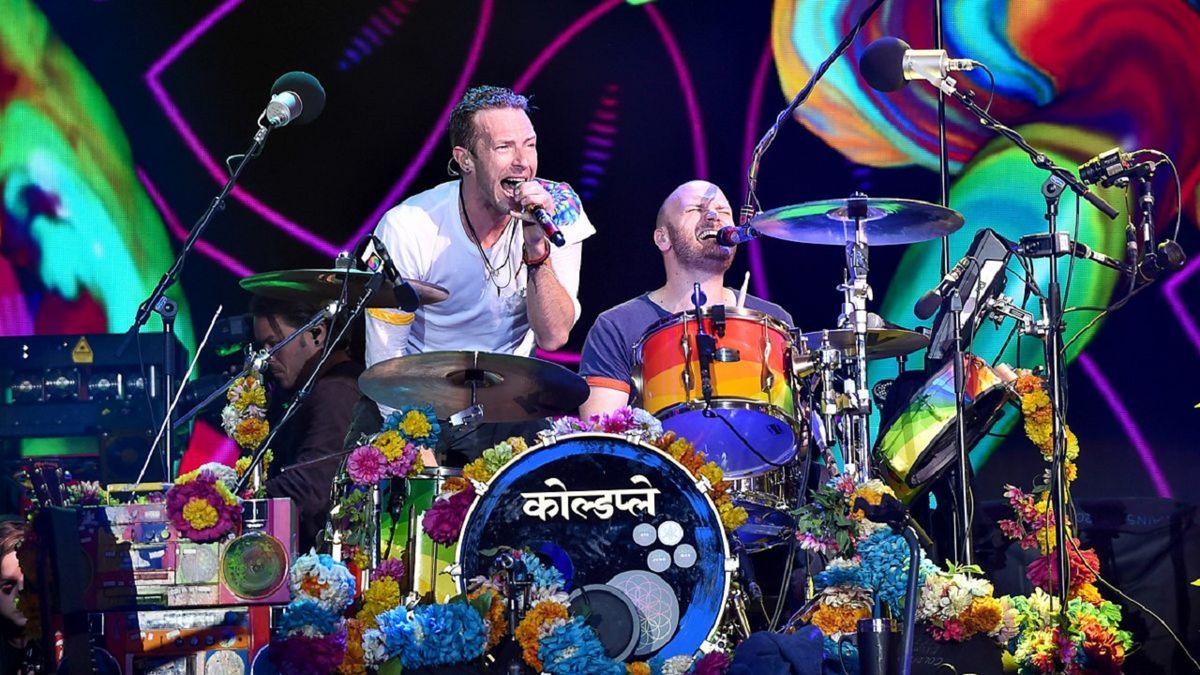 Chris Martin performing on stage with his band at Glastonbury 2016