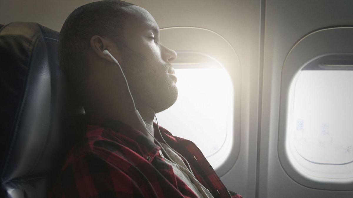 Man asleep on a plane