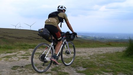 Male cyclist wearing one of the best cargo bib shorts