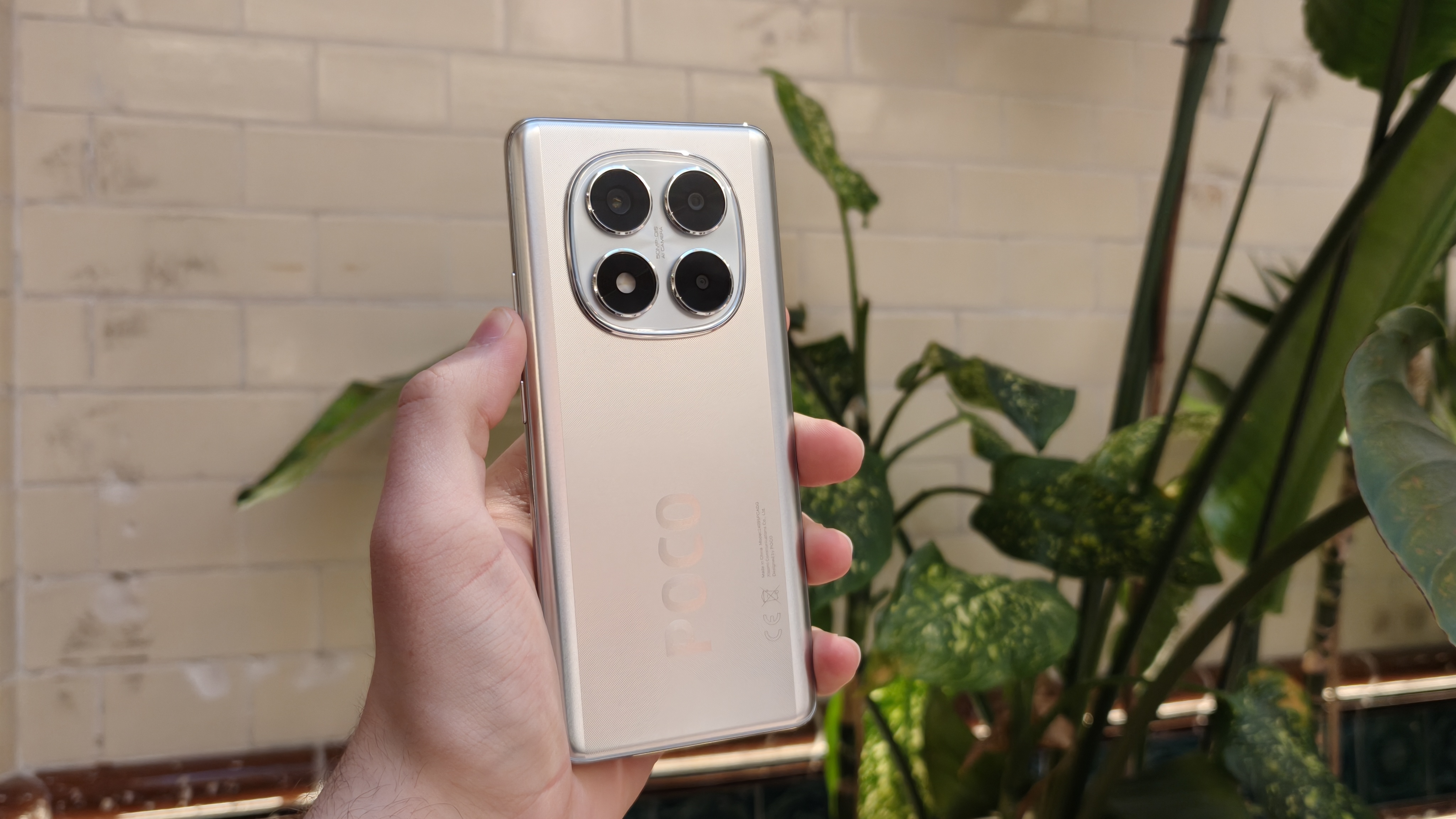 The Poco X7 against a houseplant