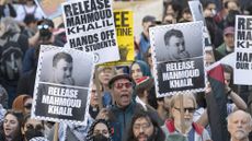 People hold up posters asking for the release of Mahmoud Khalil