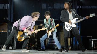 Rolling Stones guitarists Keith Richards (L), Ron Wood (C), and bass player Darryl Jones perform at the Velodrome Stadium in Marseille (south of France) 05 July 2003 during the band's first French concert for its 'Forty Licks Tour"