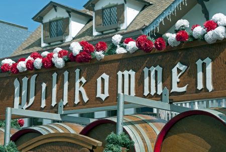 Wagon stacked with beer barrels under a sign welcoming guests to Beer Fest