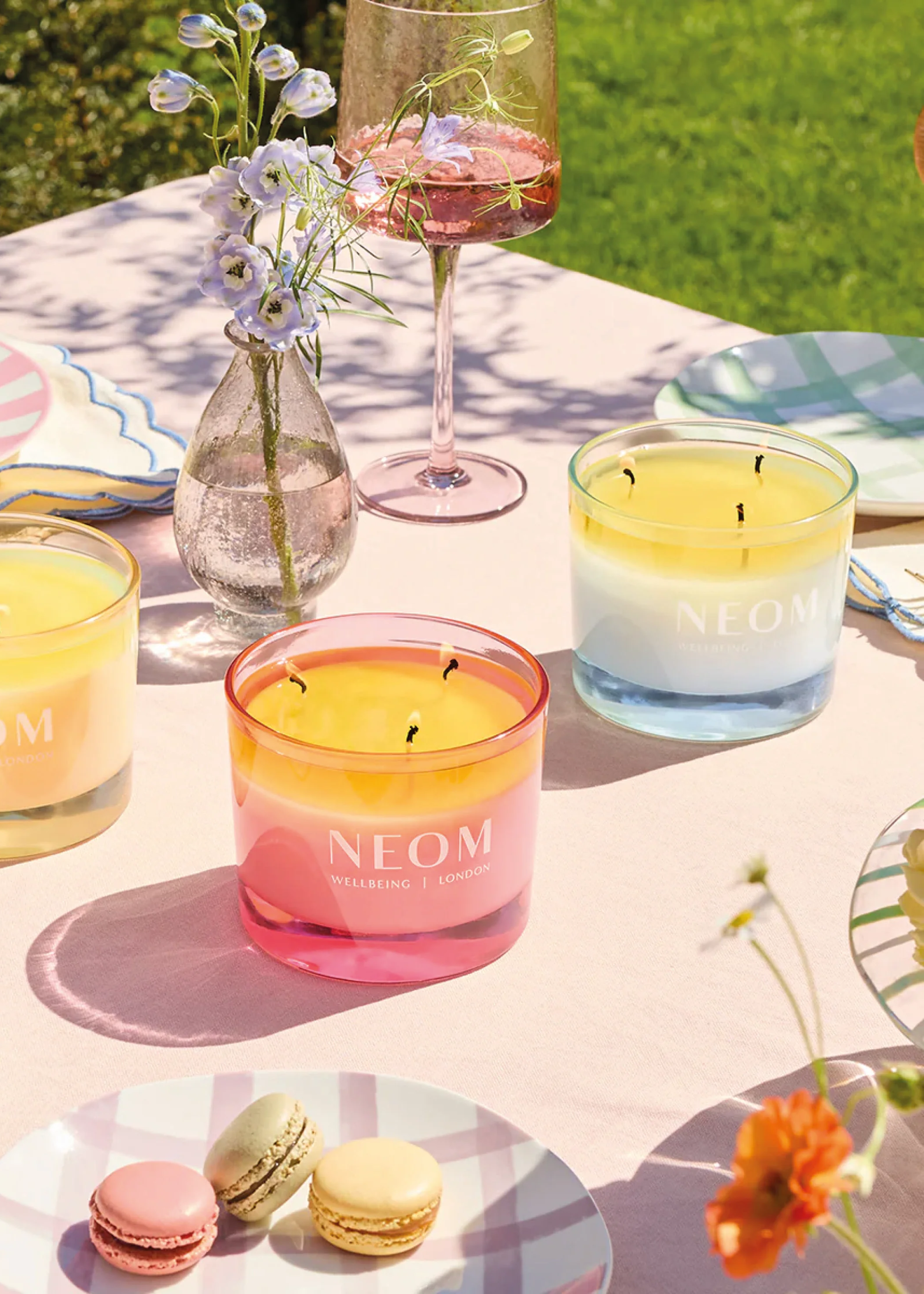 A couple of colorful garden candles on a brunch table
