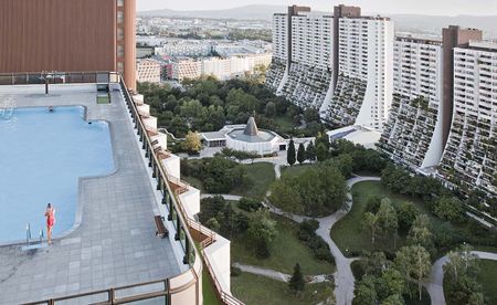 swimming pool on building terrace and lots of other buildings in the background