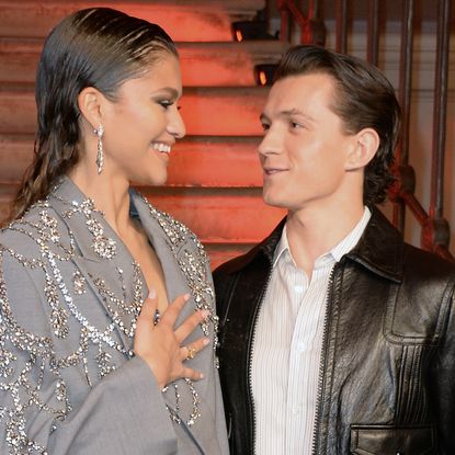 Zendaya wears a sparkly suit jacket while posing with fiance Tom Holland, who wears a leather jacket, and Zendaya poses solo at Golden Globes