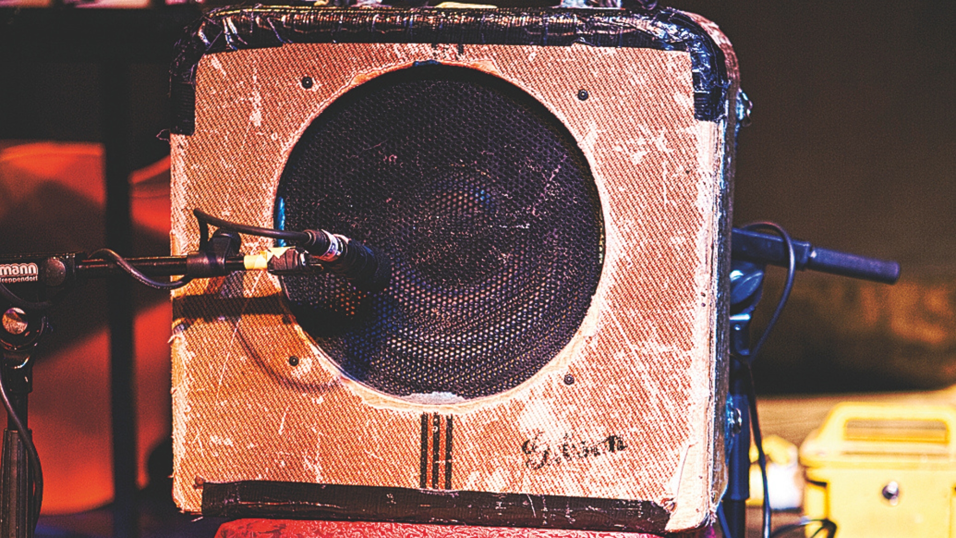 A Gibson EH-150 tube amp with a microphone on the speaker