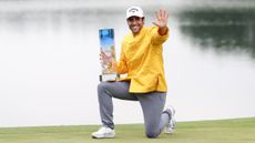 Adrian Otaegui poses with the China Open trophy and holds his hand up to indicate his fifth DP World Tour victory