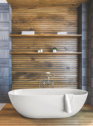 Bathroom with wood wall panels and freestanding white tub
