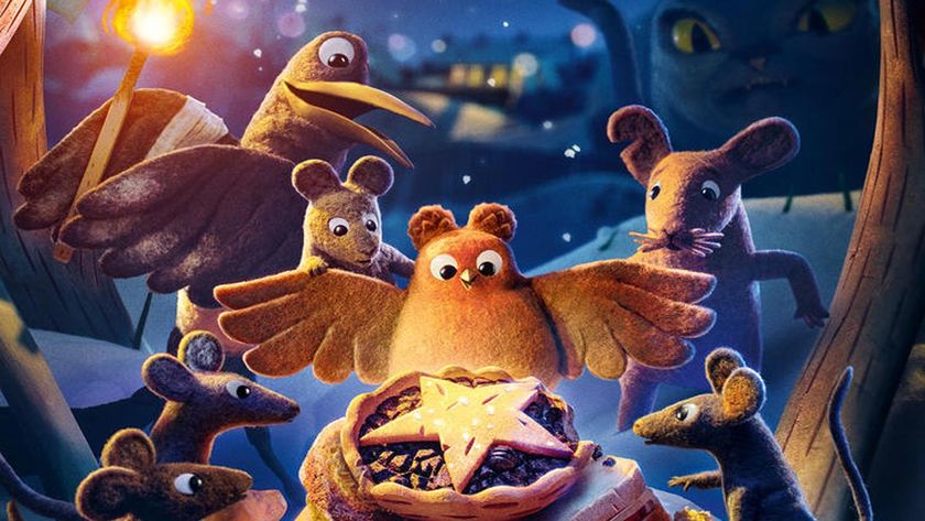 A group of felt-textured mice and a bird gather around a star-topped mince pie in a snowy outdoor scene at night.