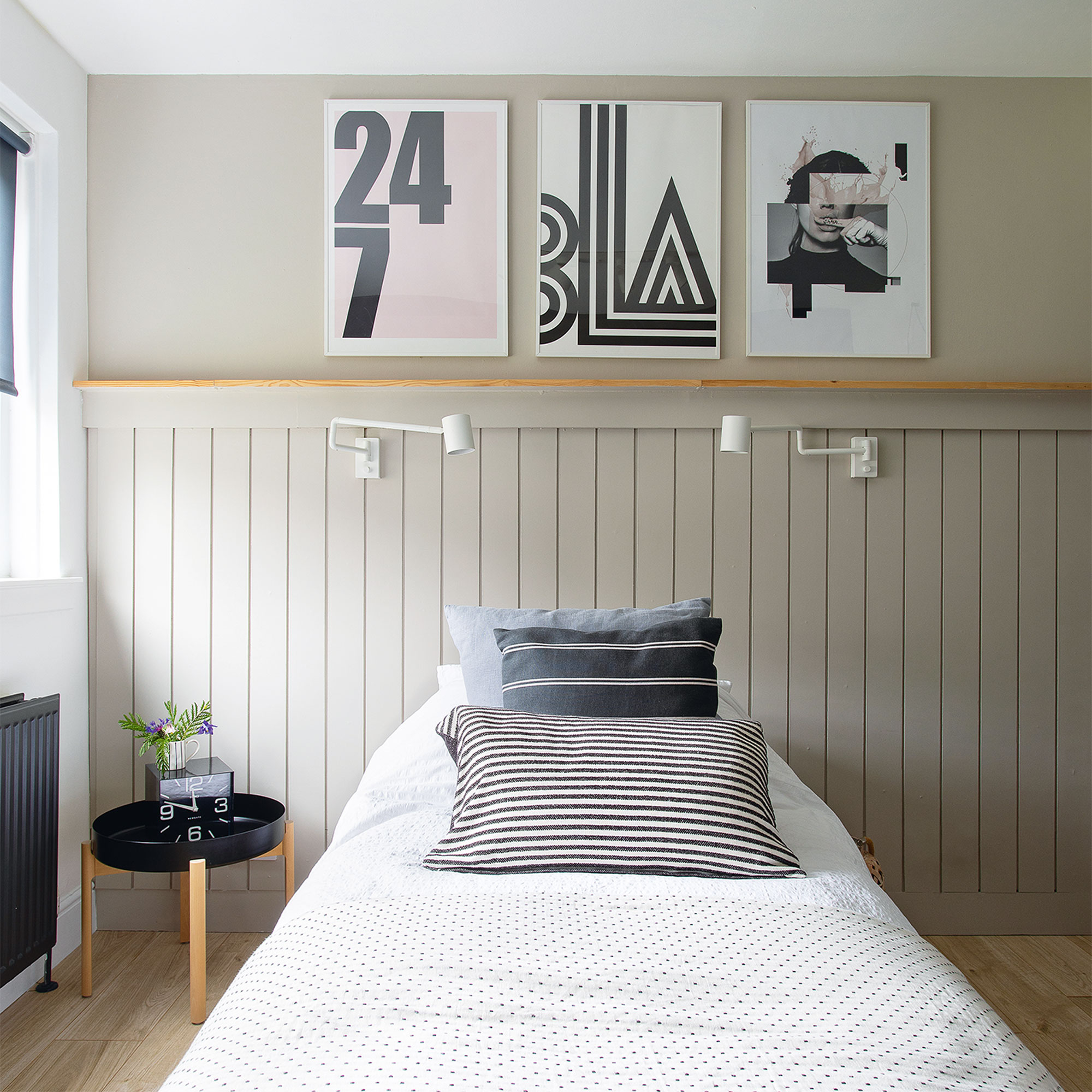 grey and white bedroom with artwork