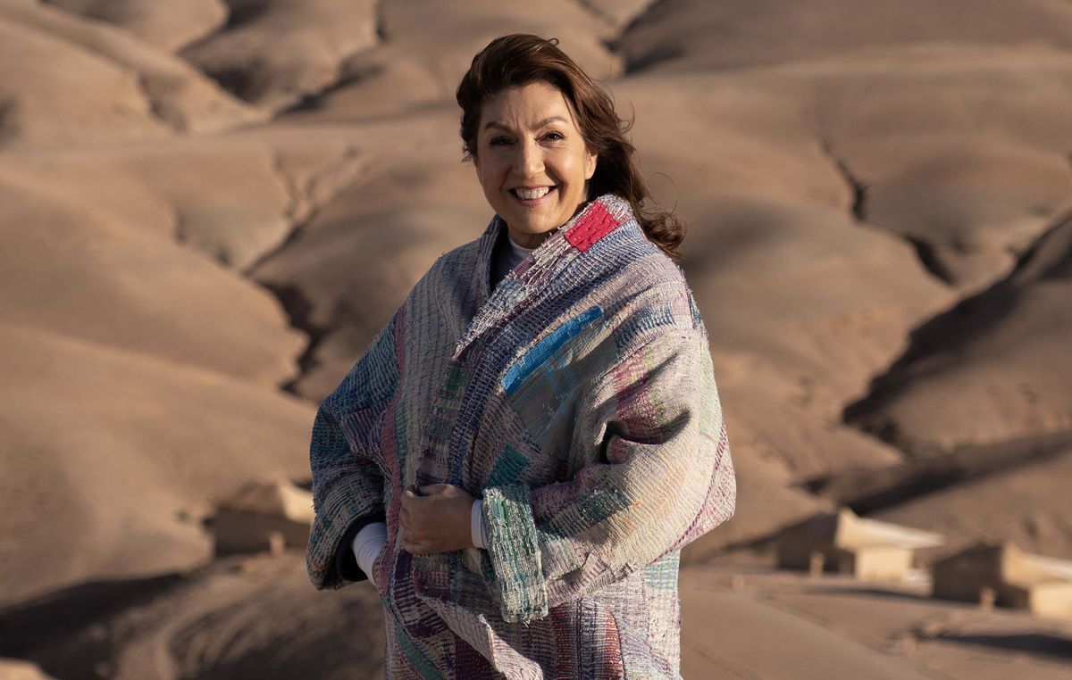 Jane McDonald smiling in the desert for Jane McDonald&#039;s Magical Morocco