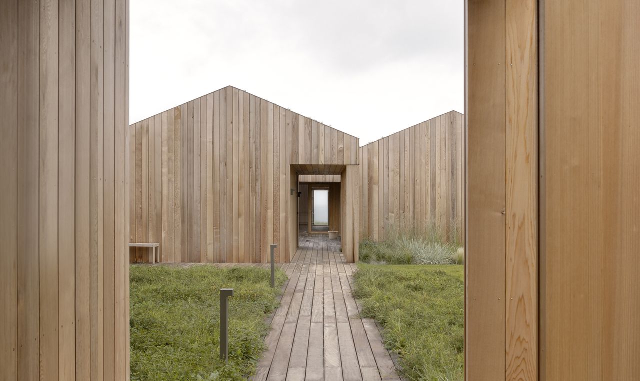 Heatherhill Beach house by Norm Architects looking at the house through the approach