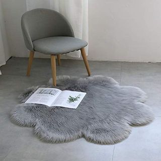 grey colour chair and faux fur rug