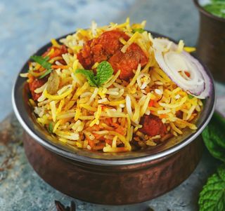 A copper bowl of biryani, a traditional rice dish found in Pakistan and the Middle East