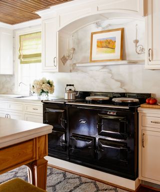 Modern farmhouse kitchen with an aga and decorative sconces