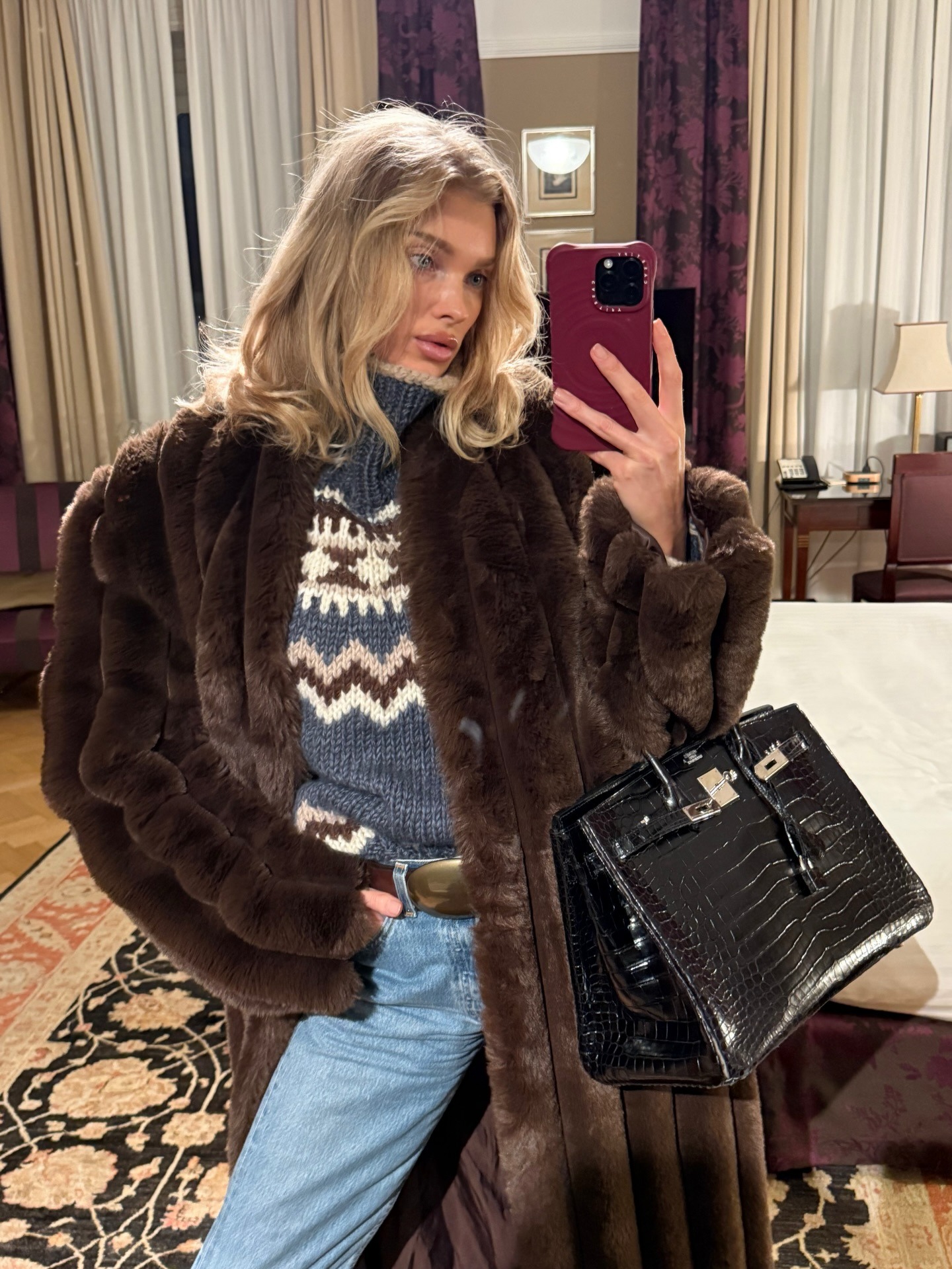 Elsa Hosk wearing a fair isle sweater with a brown coat and black Hermes bag.