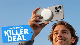 Man holding iPhone with Anker MagGo USB-C Adapter attached to the back.