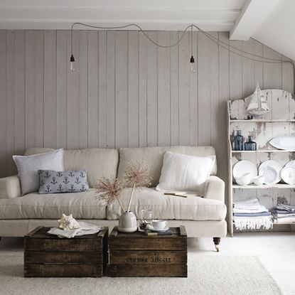 living room with wooden walls and cushions