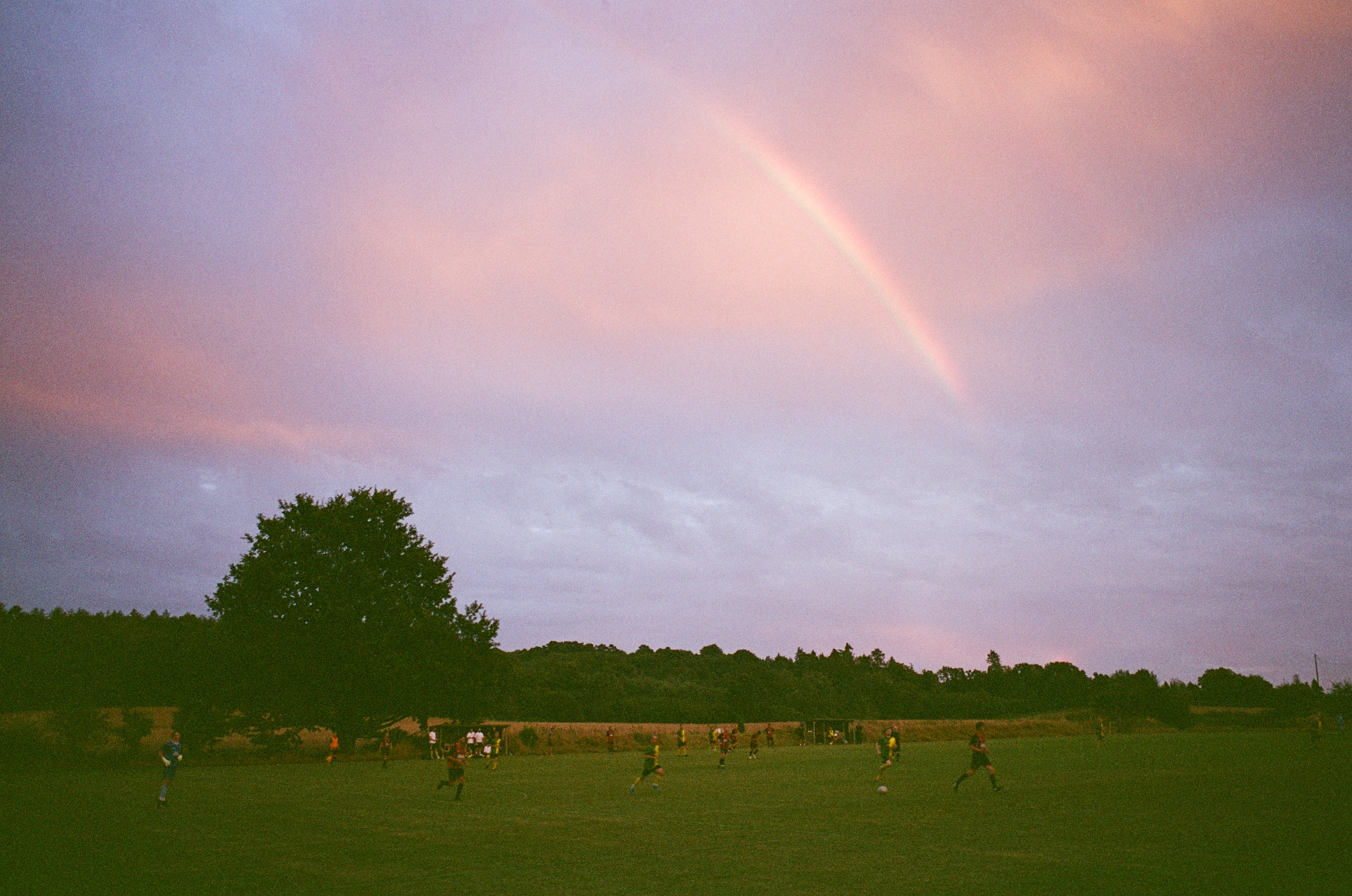 Leica MP color film scan of a grassroots football game with rainbow in the sky