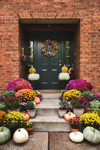 A front porch decorated with pumpkins