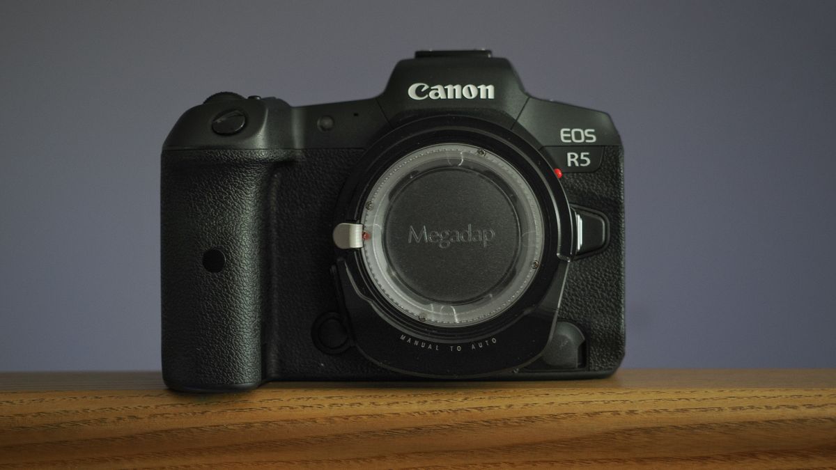 Megadap M2RF adapter mounted to a Canon EOS R5 on a wooden surface