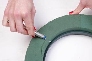 Use a craft knife to remove the edges of the wreath