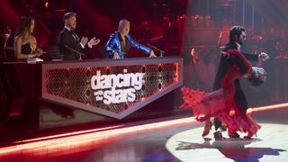 The Dancing with the Stars judges stand behind the table as they watch dancers in front of them.