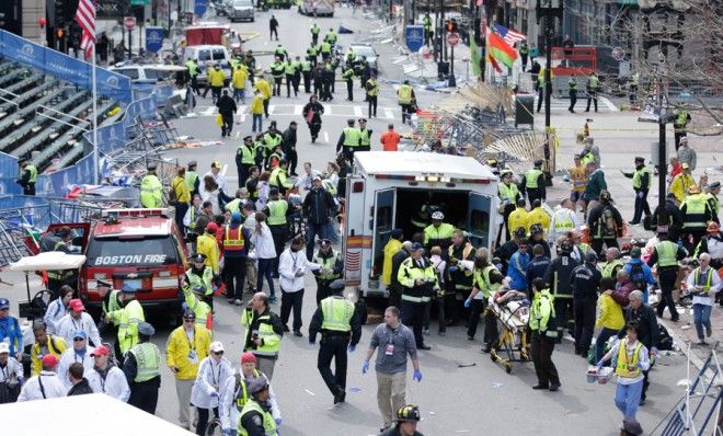 Medical workers aid injured people at the finish line.