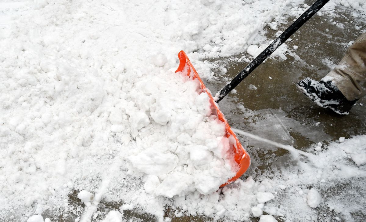 A worker uses a shovel to clear snow along Main Street during the 2017 Sundance Film Festival on January 23, 2017 in Park City, Utah. (Photo by David Becker/Getty Images)