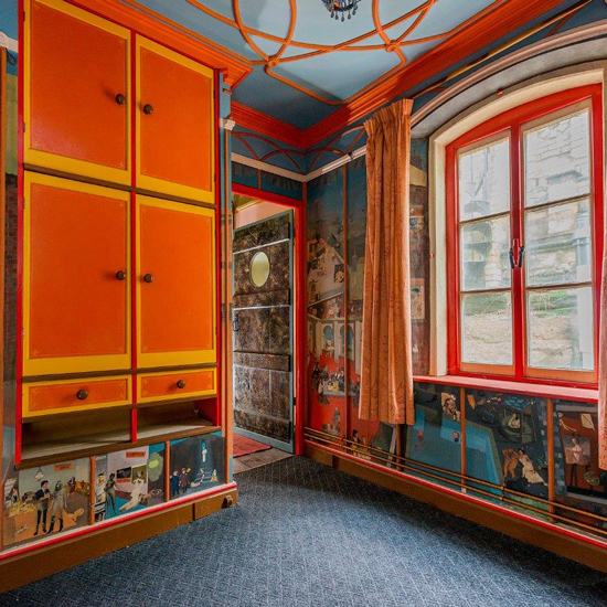 bedroom with orange cabinets and curtains