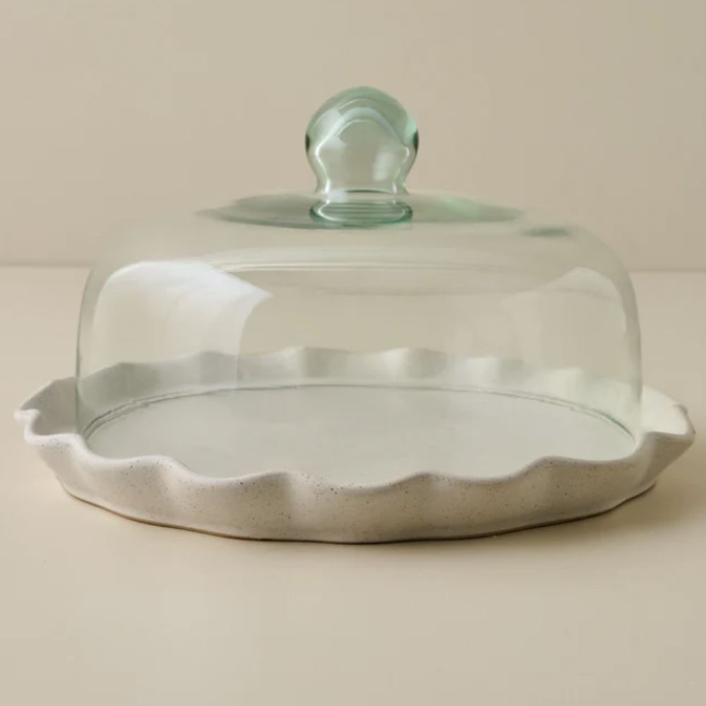 White ruffle plate with a glass cake dome on top