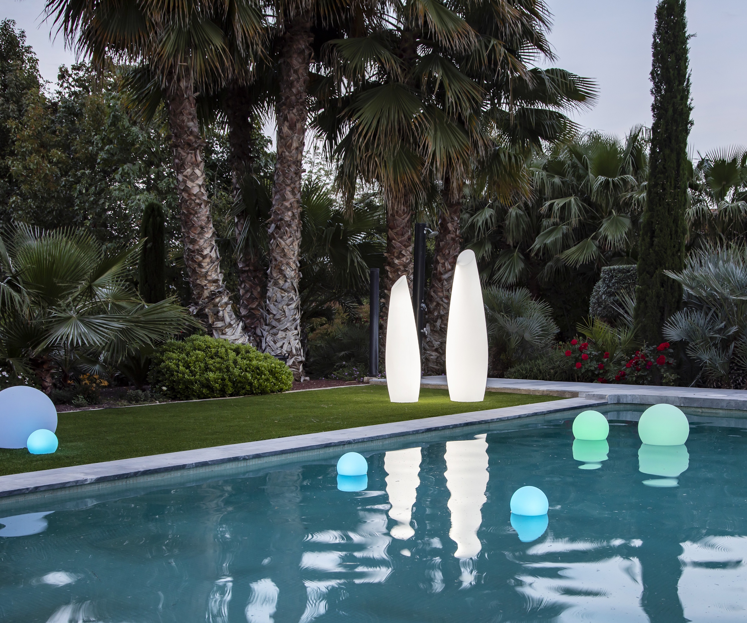 Newgarden sculptural FREDO lights next to a pool area in summer