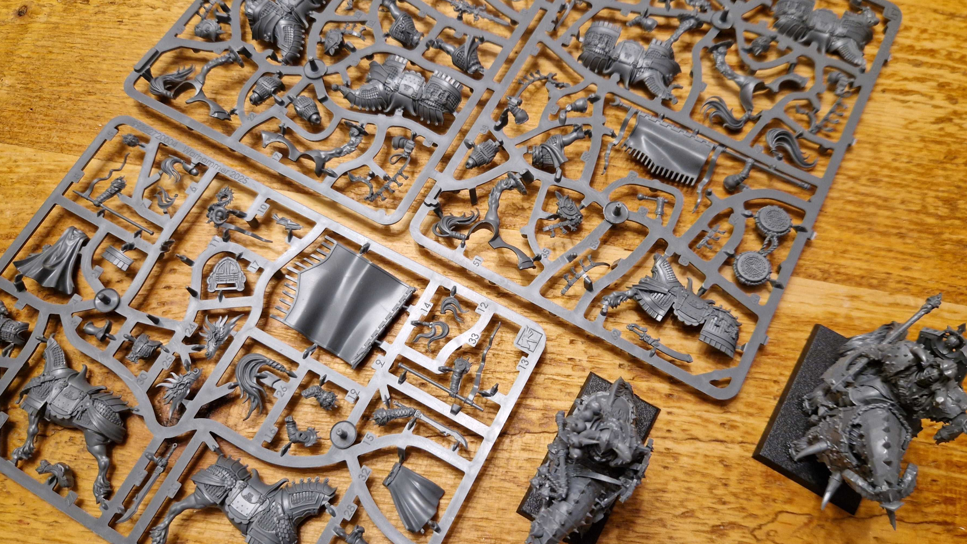 Model parts on a sprue, lying on a wooden table