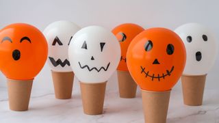 Halloween traditions with kids illustrated with hand doodled halloween balloons