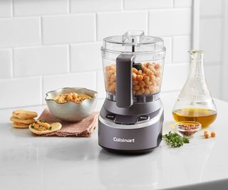 Cuisinart mini food processor on a countertop with chickpeas inside