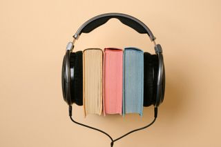 A headset over three print books.