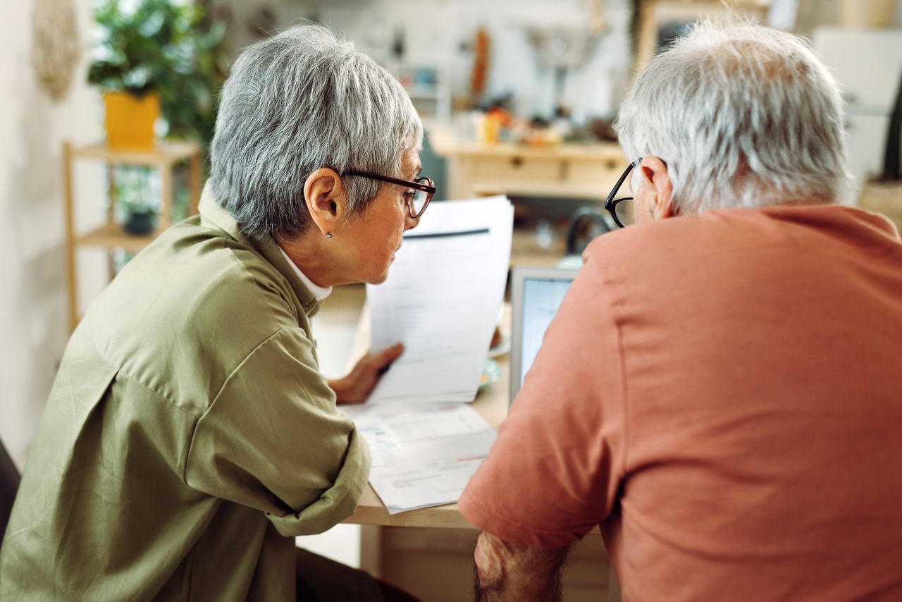 Senior couple going over bills at home