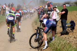 Kasper Asgreen stops to try and deal with a mechanical malady at Paris-Roubaix