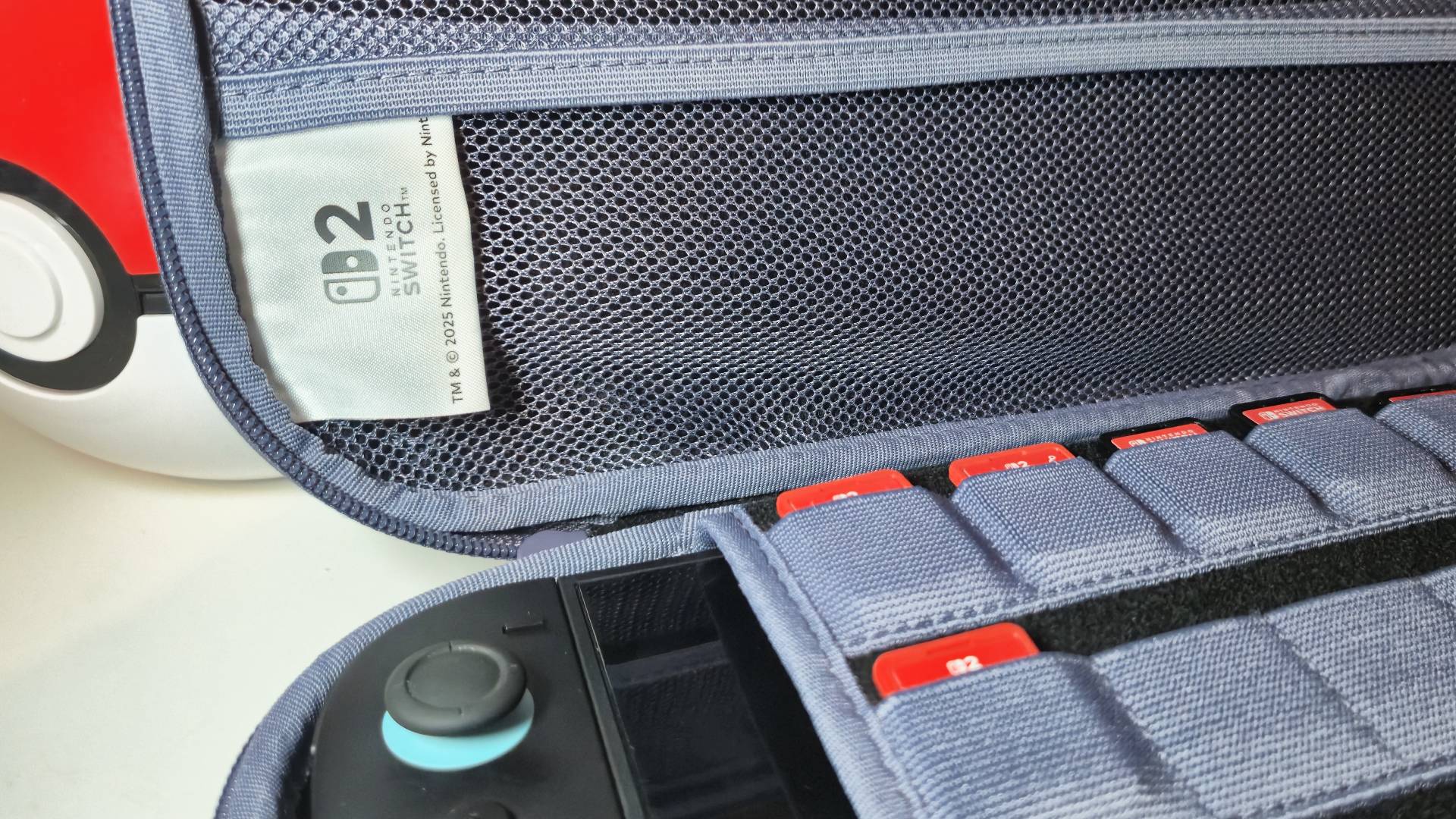 Photo of the inside of a Hori Switch 2 case showing a pastel purple and black interior.