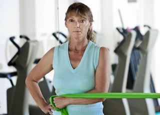 Woman doing rotator cuff exercise with a resistance band