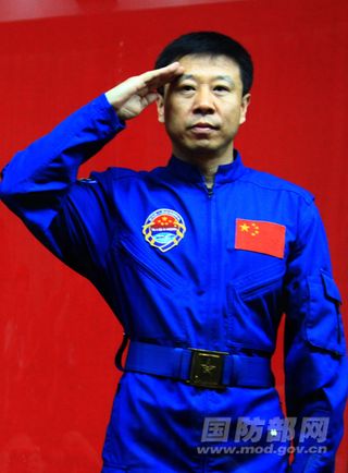 China's Shenzhou 9 astronaut Liu Wang, a senior colonel in the People's Liberation Army, salutes to reporters on June 15, 2012.