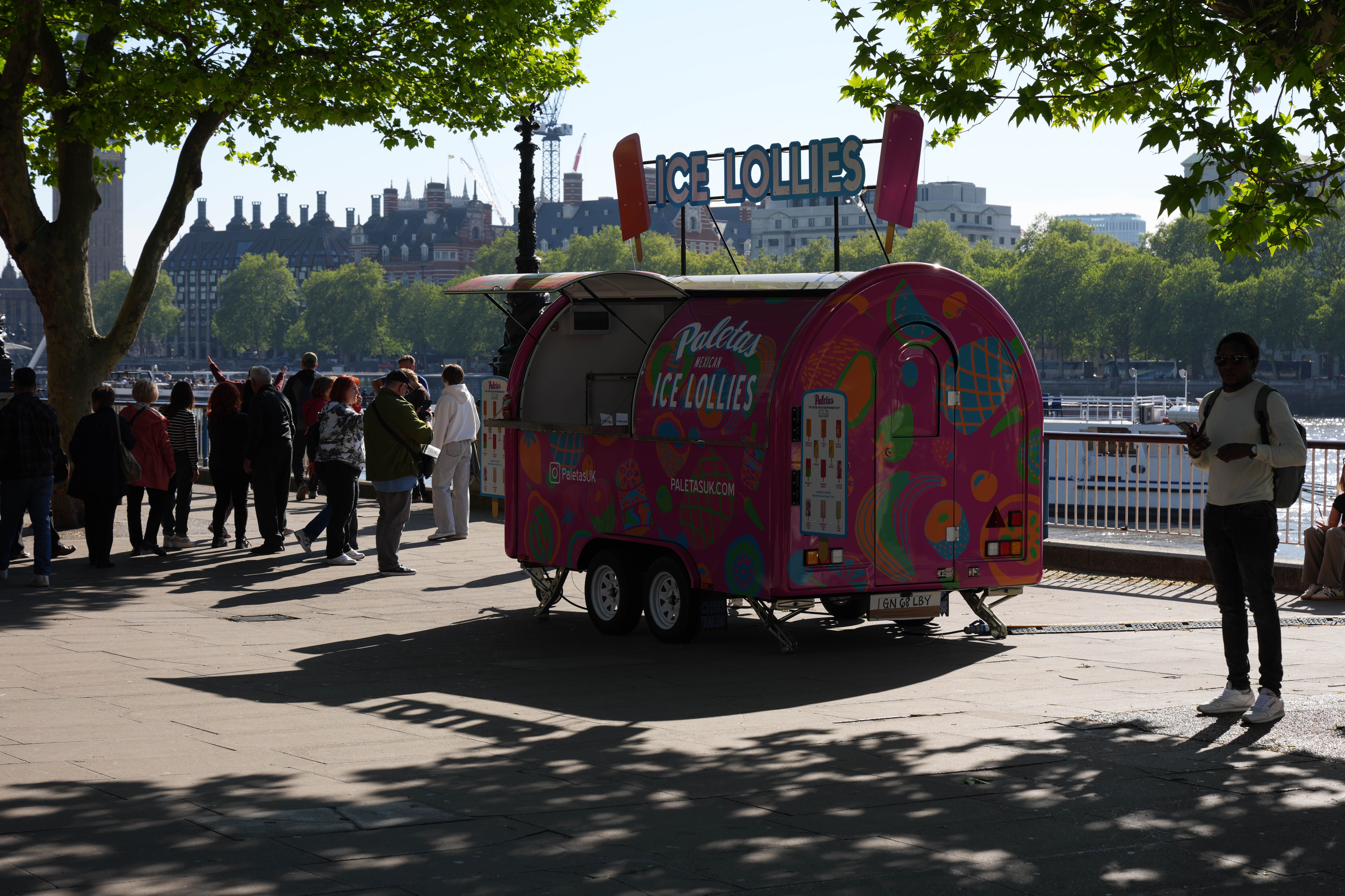 Ice lollies trailer on the South Bank in deep shade and sunlight.