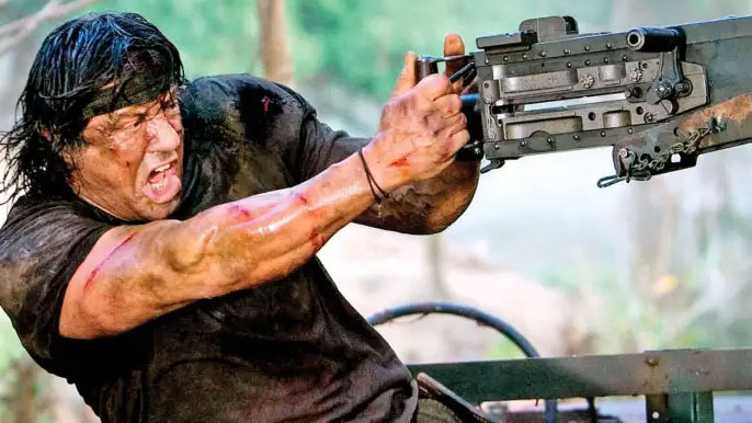 Sylvester Stallone as Rambo, holding a gun and looking angry