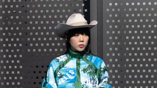 Susie Lau is seen wearing a fedora ahead of the Gucci fashion show wearing a cowboy hat during the Milan Fashion Week Fall/Winter 2022/2023 on February 25, 2022 in Milan, Italy.